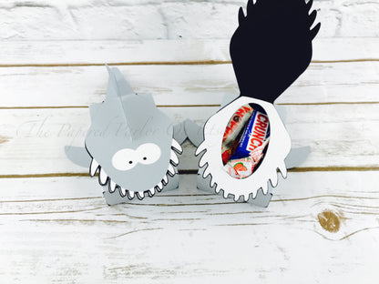 Shark party box. The box displays a party box shaped like a shark that opens his mouth to reveal all his teeth. There is an open area where you can fill the box with party treats.
