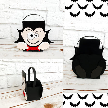 Vampire Halloween party box. The vampire box is black but has the face of a vampire wearing a red bow tie on the front with his hands at the bottom. His cute dress shoes are displayed on the back of the box.